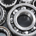 How should used wheel bearings cleaned before inspection?