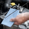 Which fluids must be checked when the car is cold?